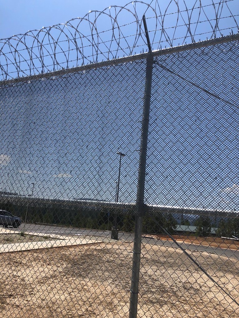 Modular galvanized chain-link dog kennel assembled on a Humboldt County property