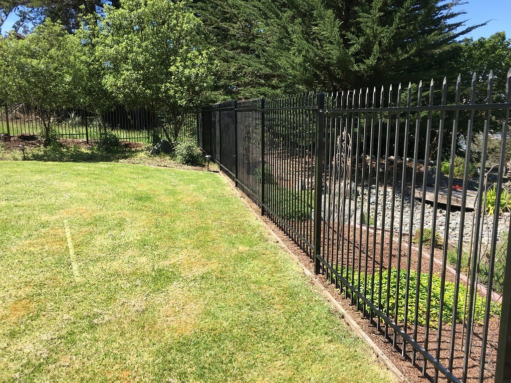 Example of black ornamental iron fence along a landscape edge on a Humboldt County estate