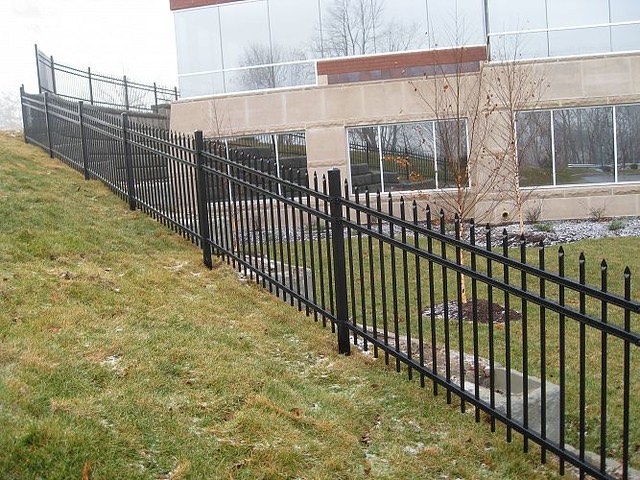 Ornamental iron entry gate for a residence