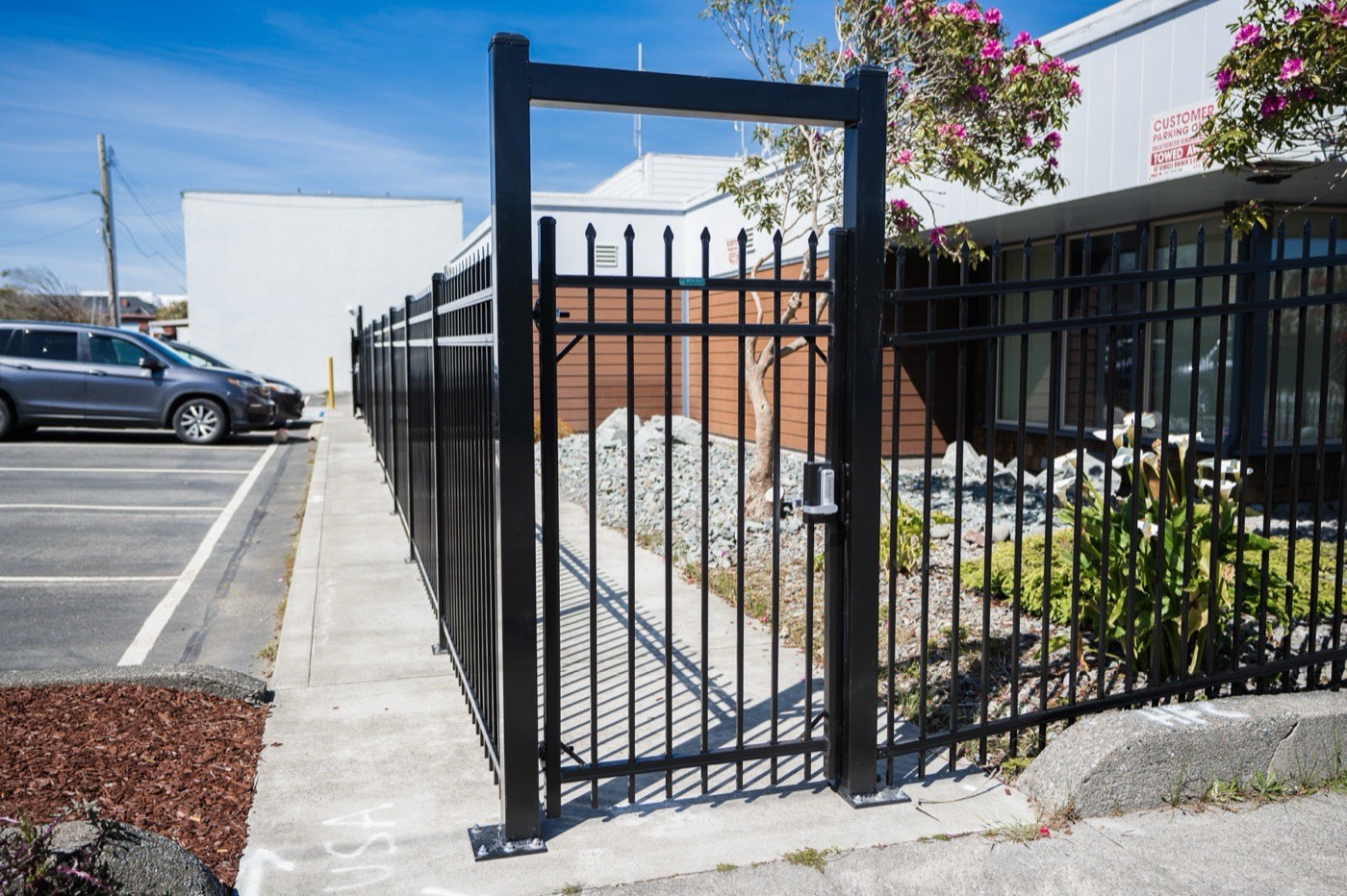 Custom dual-leaf ornamental iron entry gate at the Humboldt Bay Municipal Water District site in Eureka