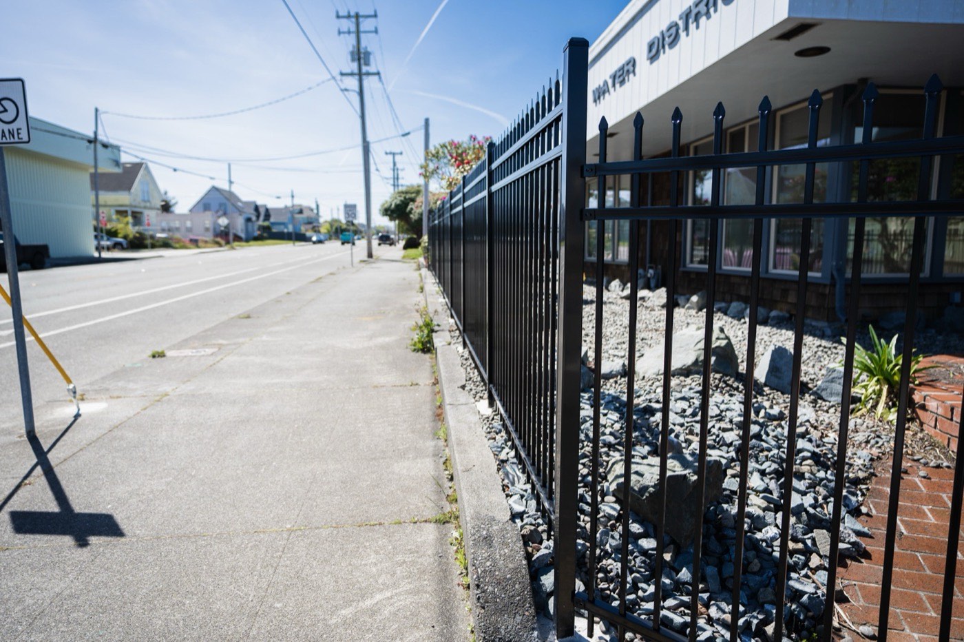 Streetside view of black powder-coated ornamental iron fence along the Humboldt Bay Municipal Water District in Eureka