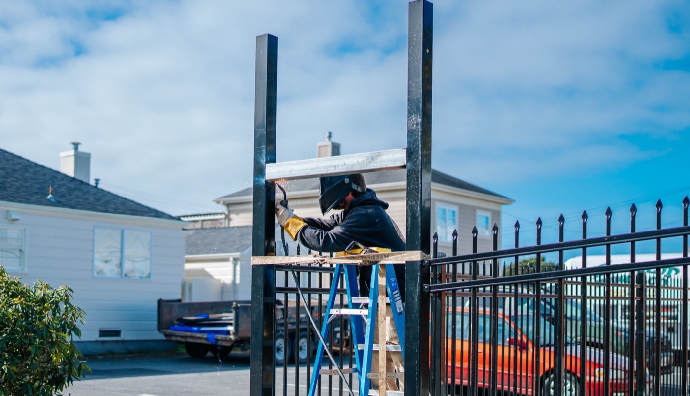 Humboldt Fence installer welding ornamental iron post detail at a residential property