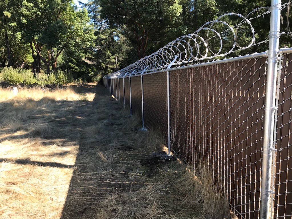 Example of slat Master chain link fence with factory-woven privacy slats on a Humboldt County property