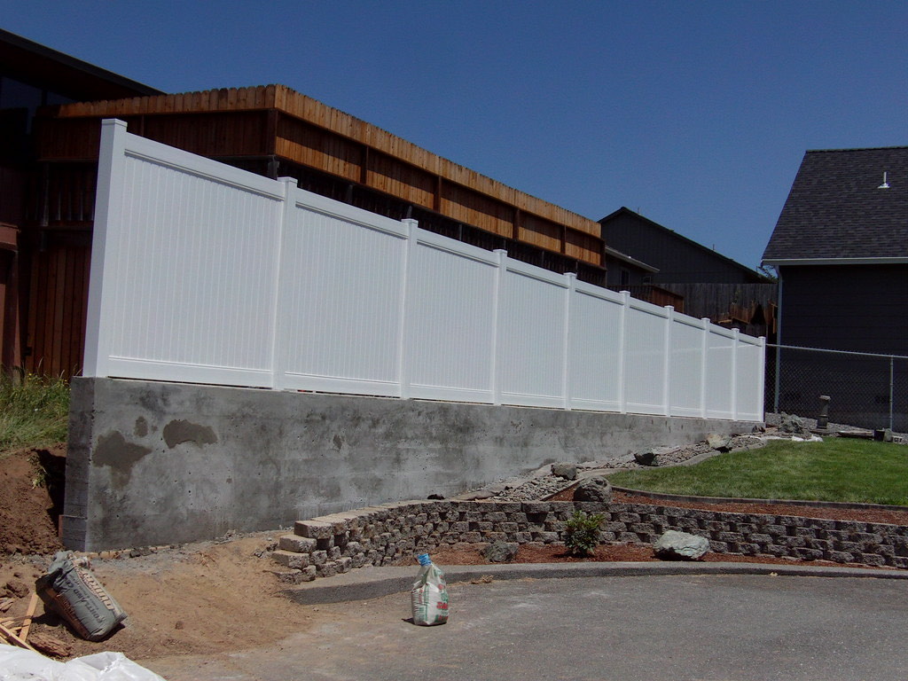 Vinyl fence installation along a Humboldt property line