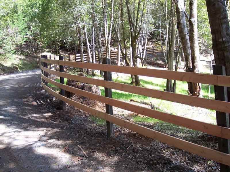Wooden split-rail agricultural fence on a grassy Humboldt County hillside