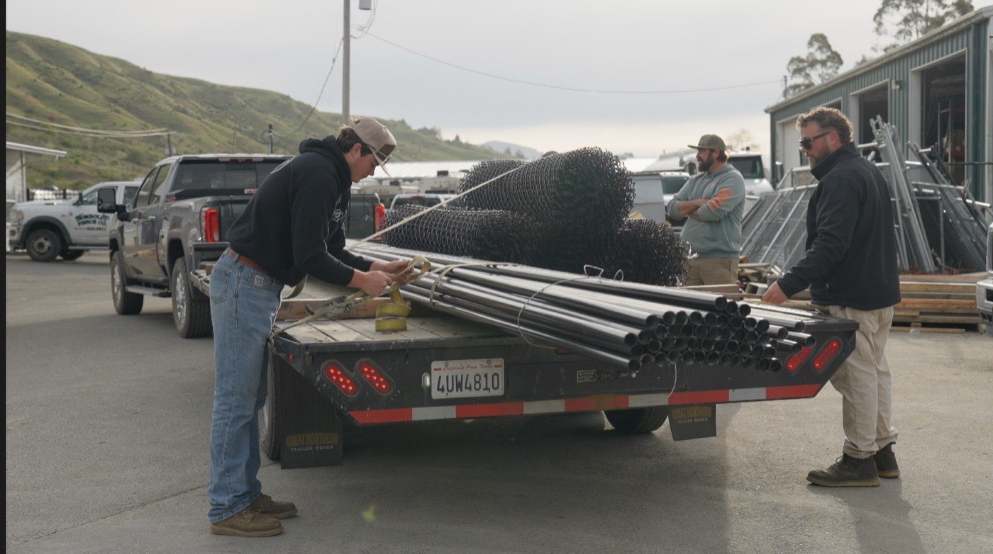 Humboldt Fence crew loading chain link rolls onto a flatbed at the Fortuna yard